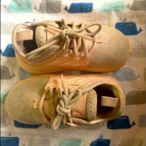 Worn pink adidas sneakers